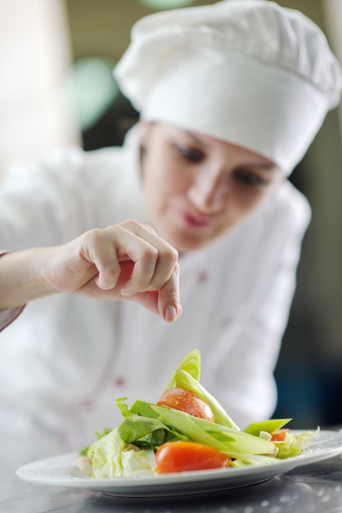 beautiful young chef woman prepare and decorating tasty food in kitchen